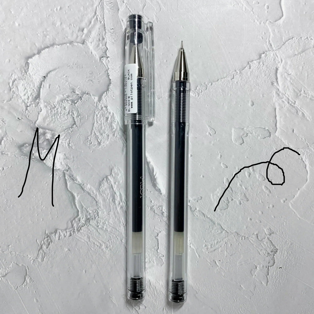 Two pens on a textured white surface with artistic lines.