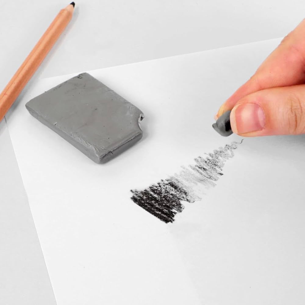 Hand holding a gray eraser over a white surface with a pencil and erased mark.
