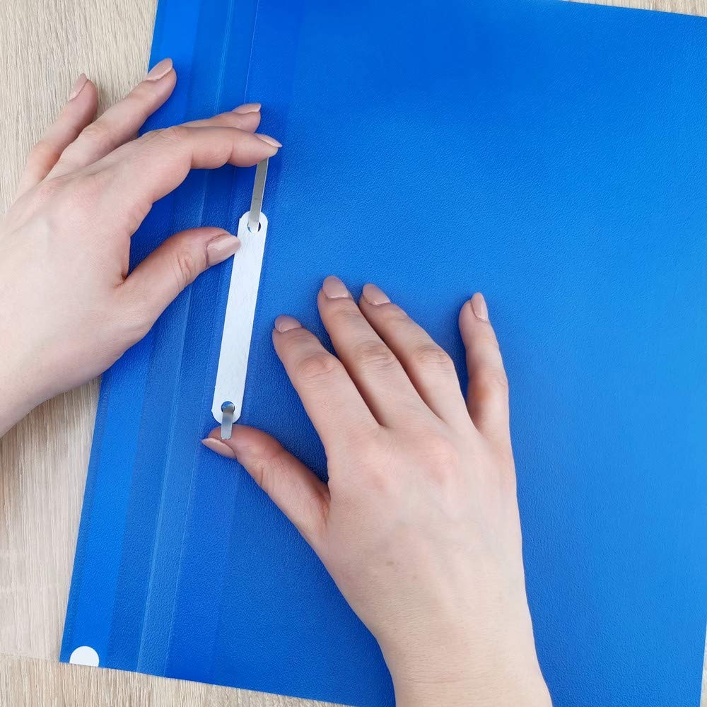 Person using a hole punch on a blue sheet of paper.