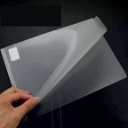 Clear plastic sheet held by a hand on a dark background