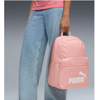 Person holding a pink Puma backpack with a plain background