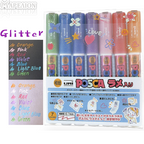 Set of Uni Posca glitter markers with colorful caps on a white background